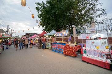 A group of people walking on a street

Description automatically generated